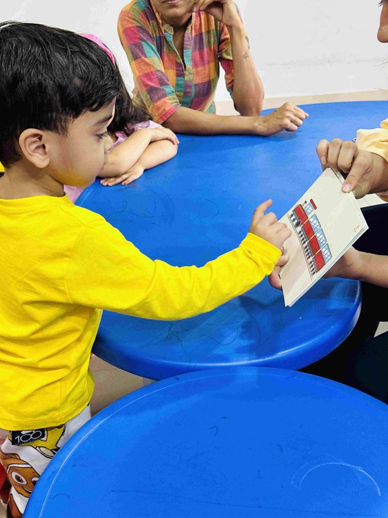 Child sorting flashcards by category during a learning activity