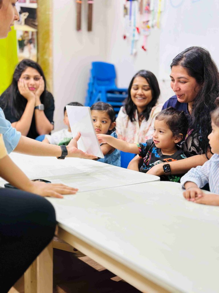 Parent and toddler playing a flashcard game together at Tickle Right Classes